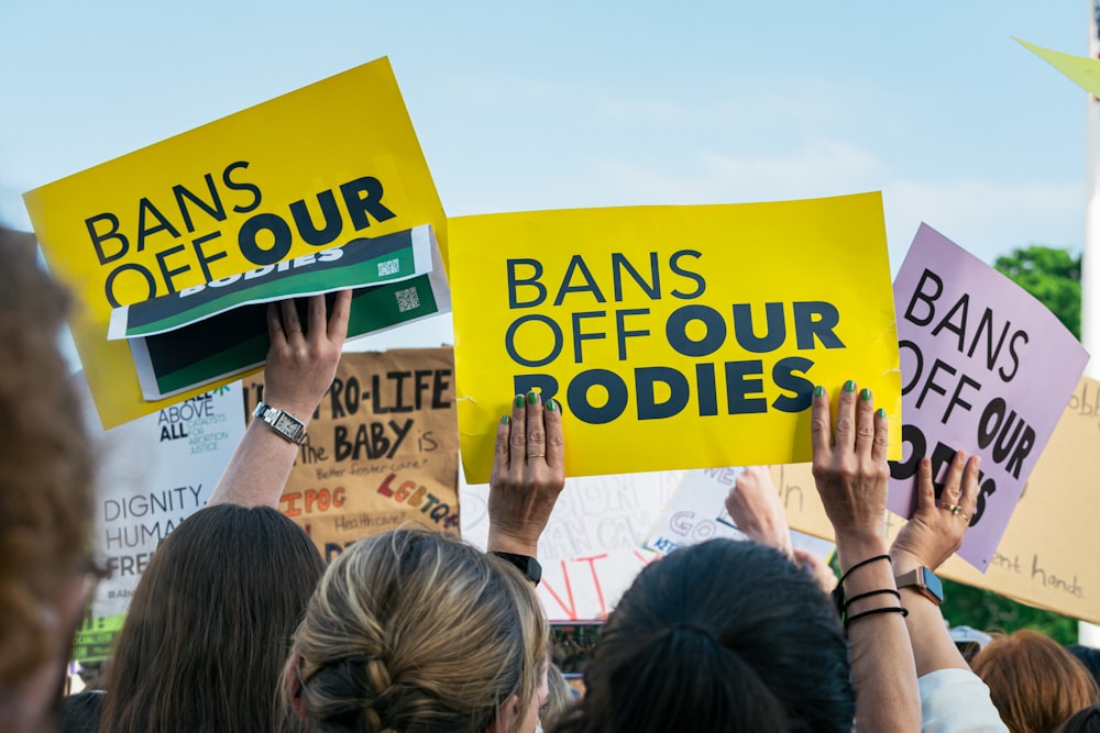 a group of people holding signs