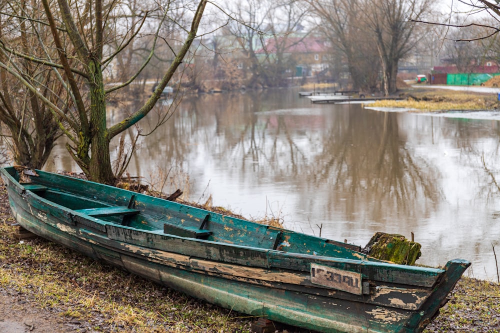 a boat sits on the side of a river