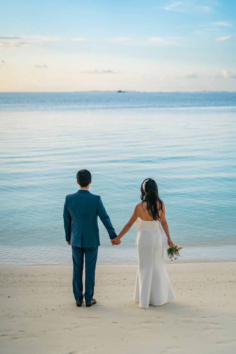 a man and woman walking on a beach