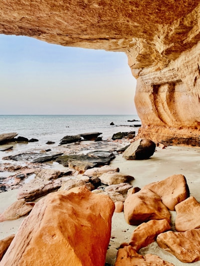 a rocky beach with a large arch