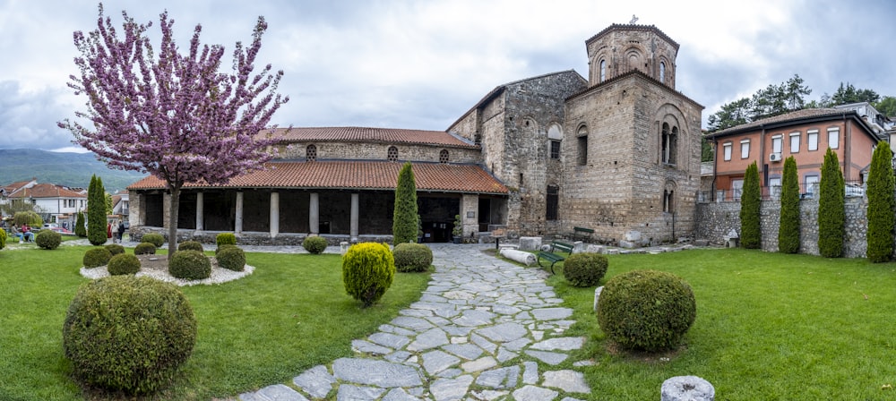 a large building with a courtyard and a large garden in front of it