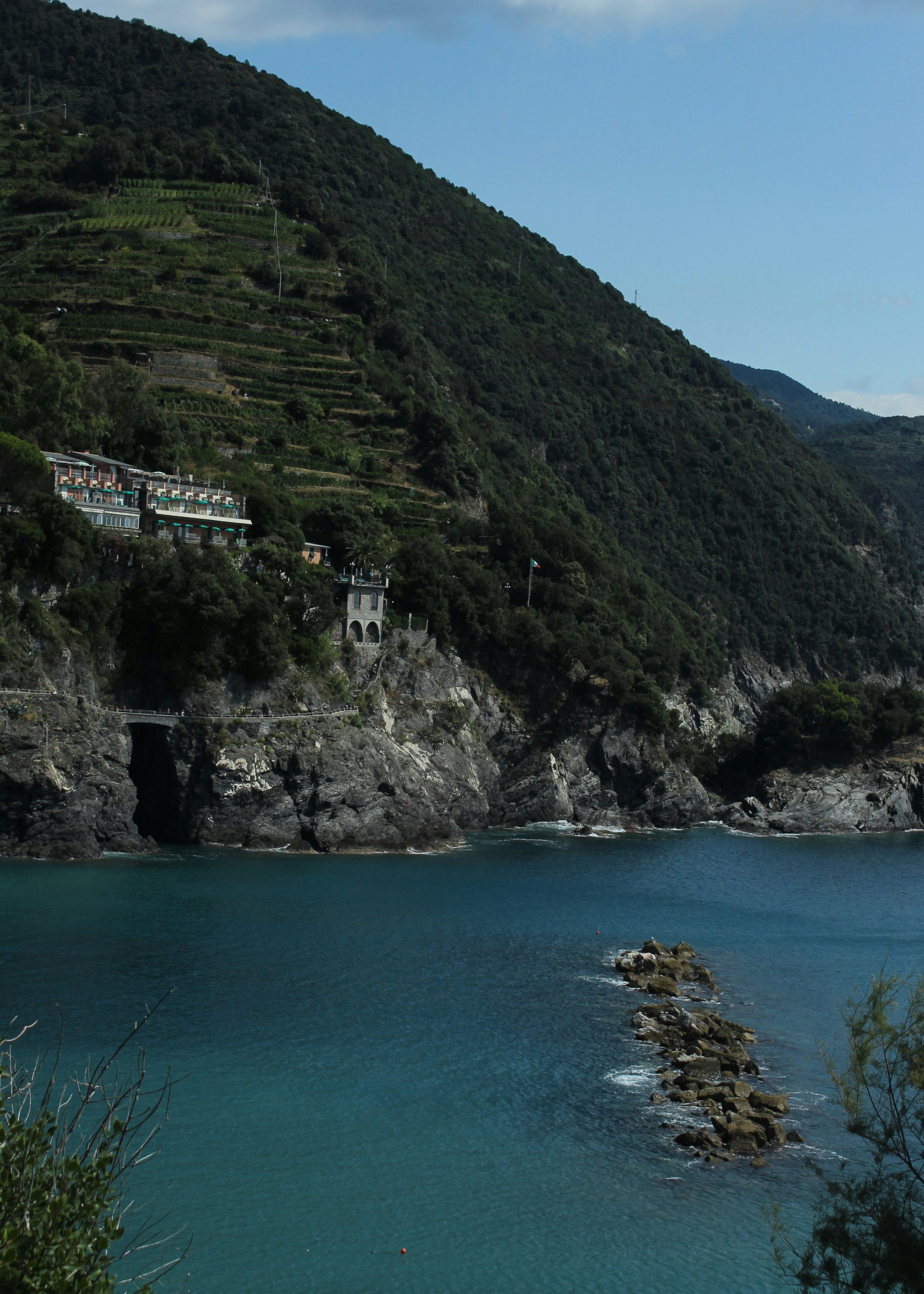 a building on a cliff by a body of water