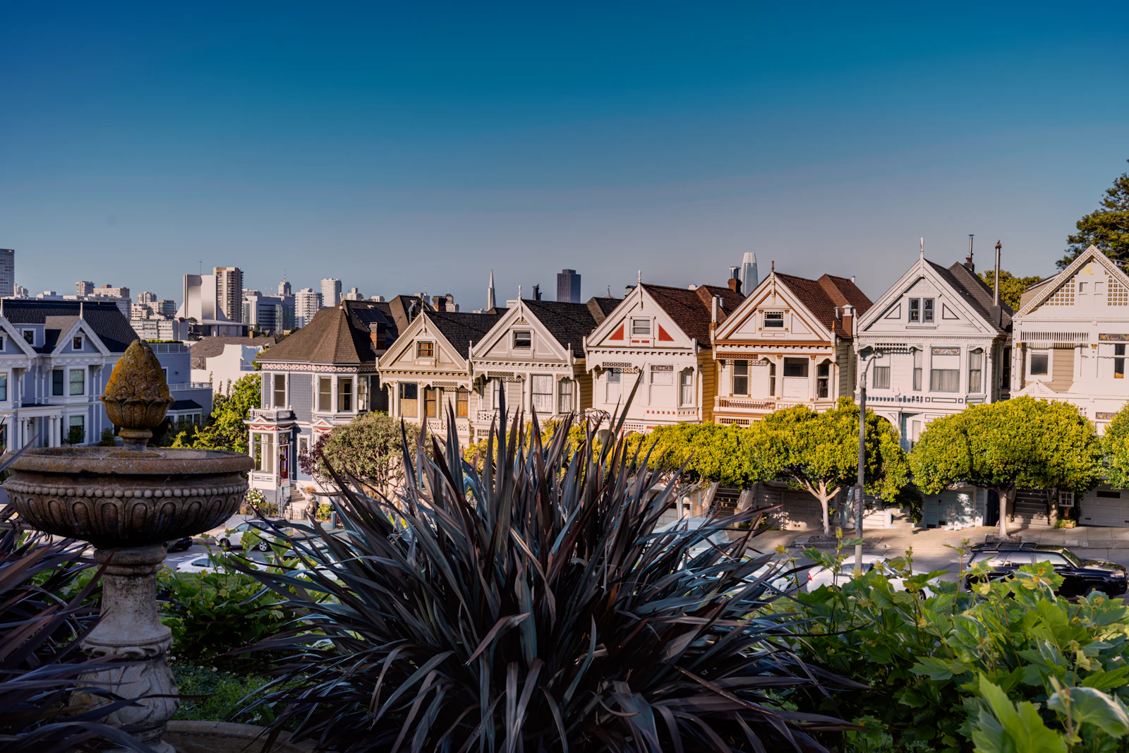 A row of tall Victorian houses side by side.