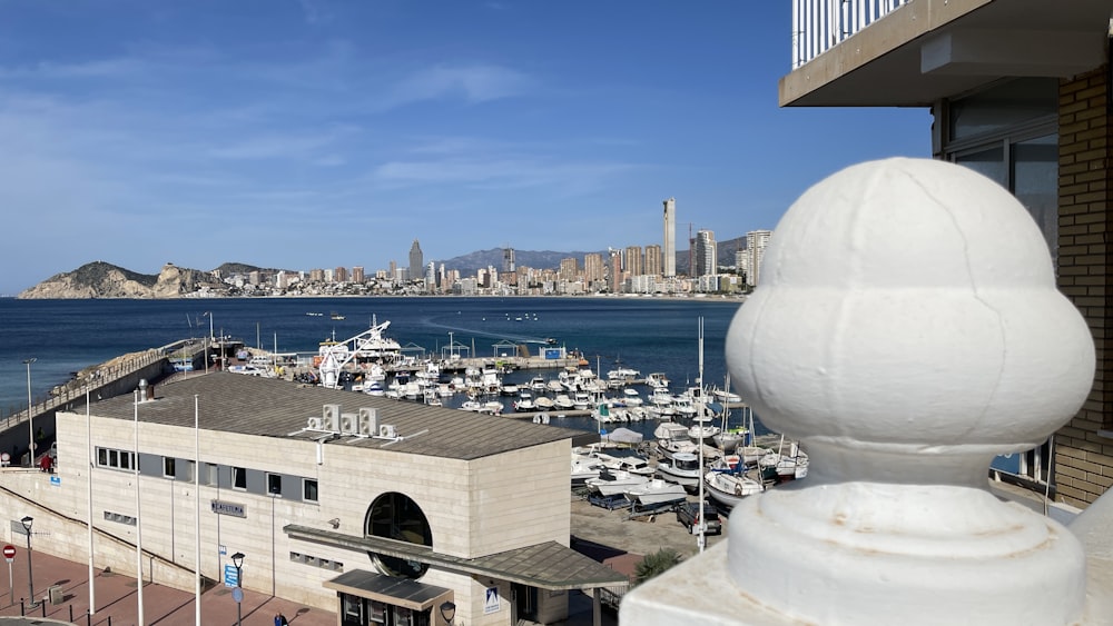 a large white statue next to a body of water