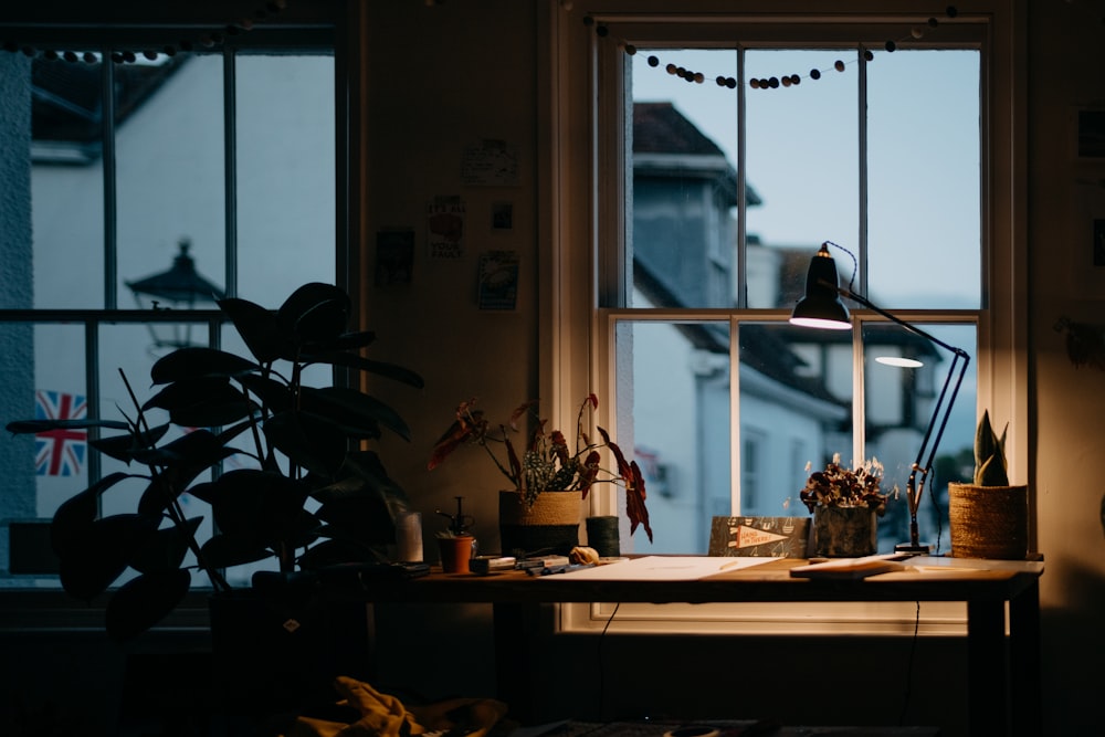 a vase of flowers on a table next to a window