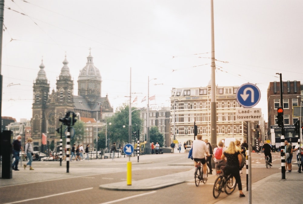 people riding bikes on a street