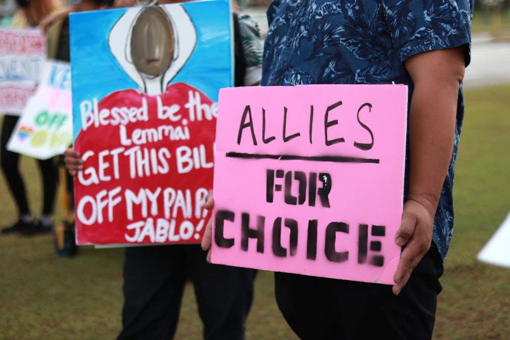 a couple of people holding signs