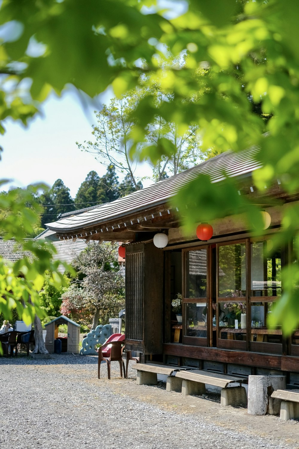 a building with a roof and a tree in the back