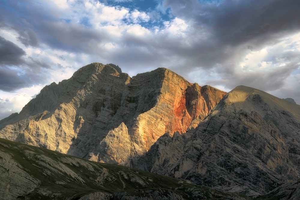 a mountain with clouds above it