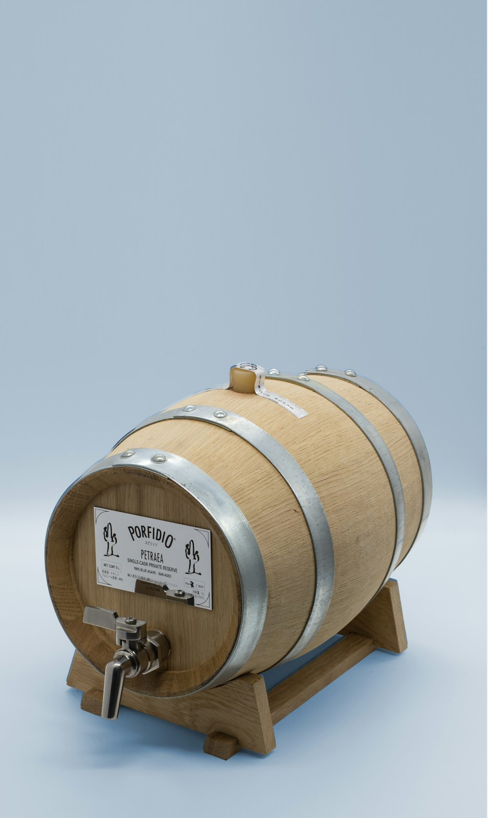 a wooden barrel with a sign on it