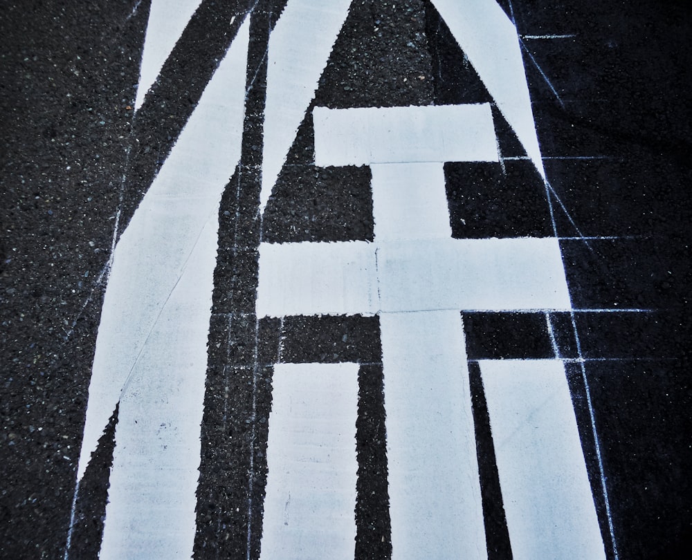 a black and white striped crosswalk sign