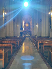 A vibrant congregation worshipping together under radiant light beams.