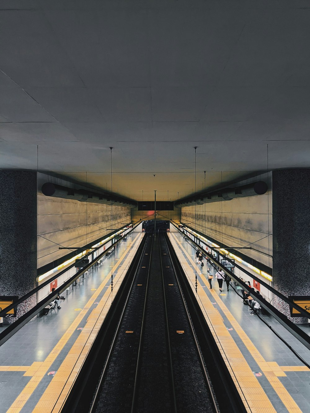 a train station with people walking