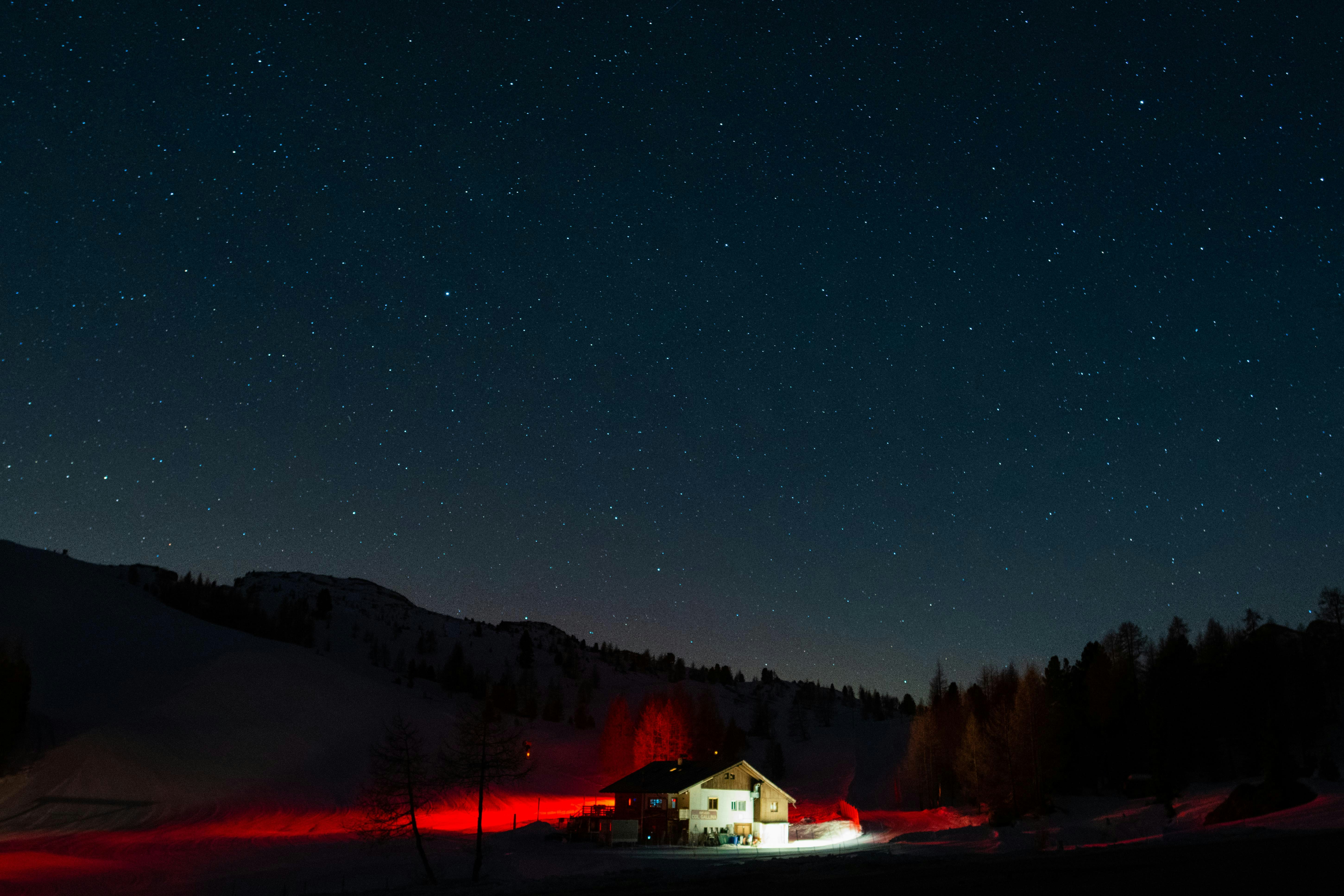 Snowy hut in the Italian Dolomites at night