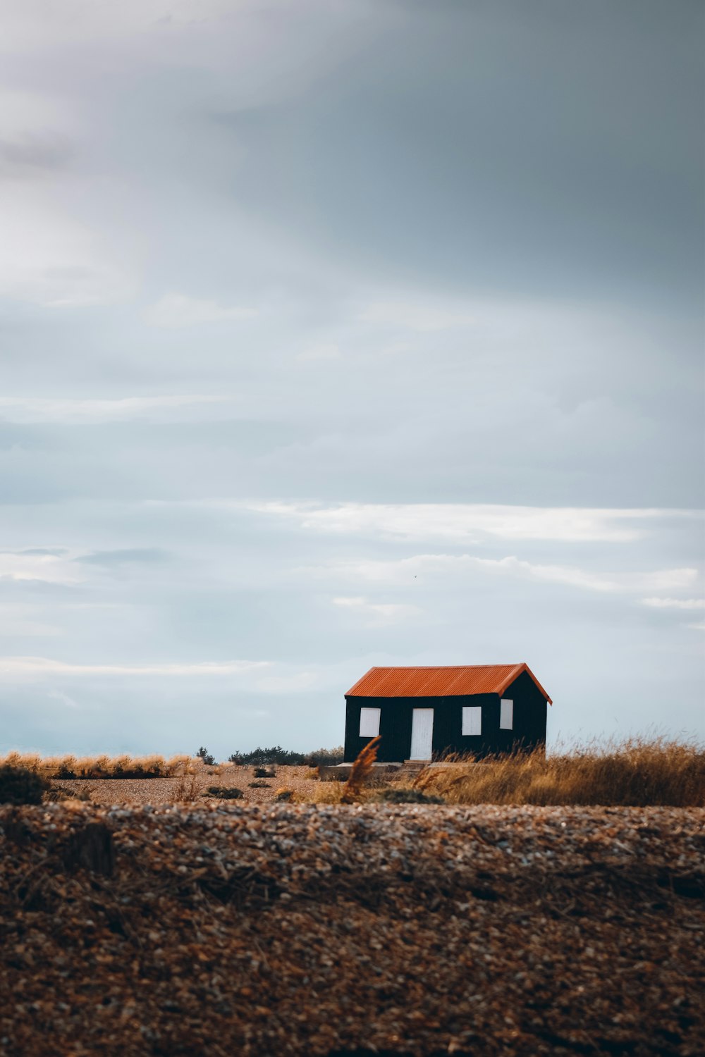 a small building on a beach