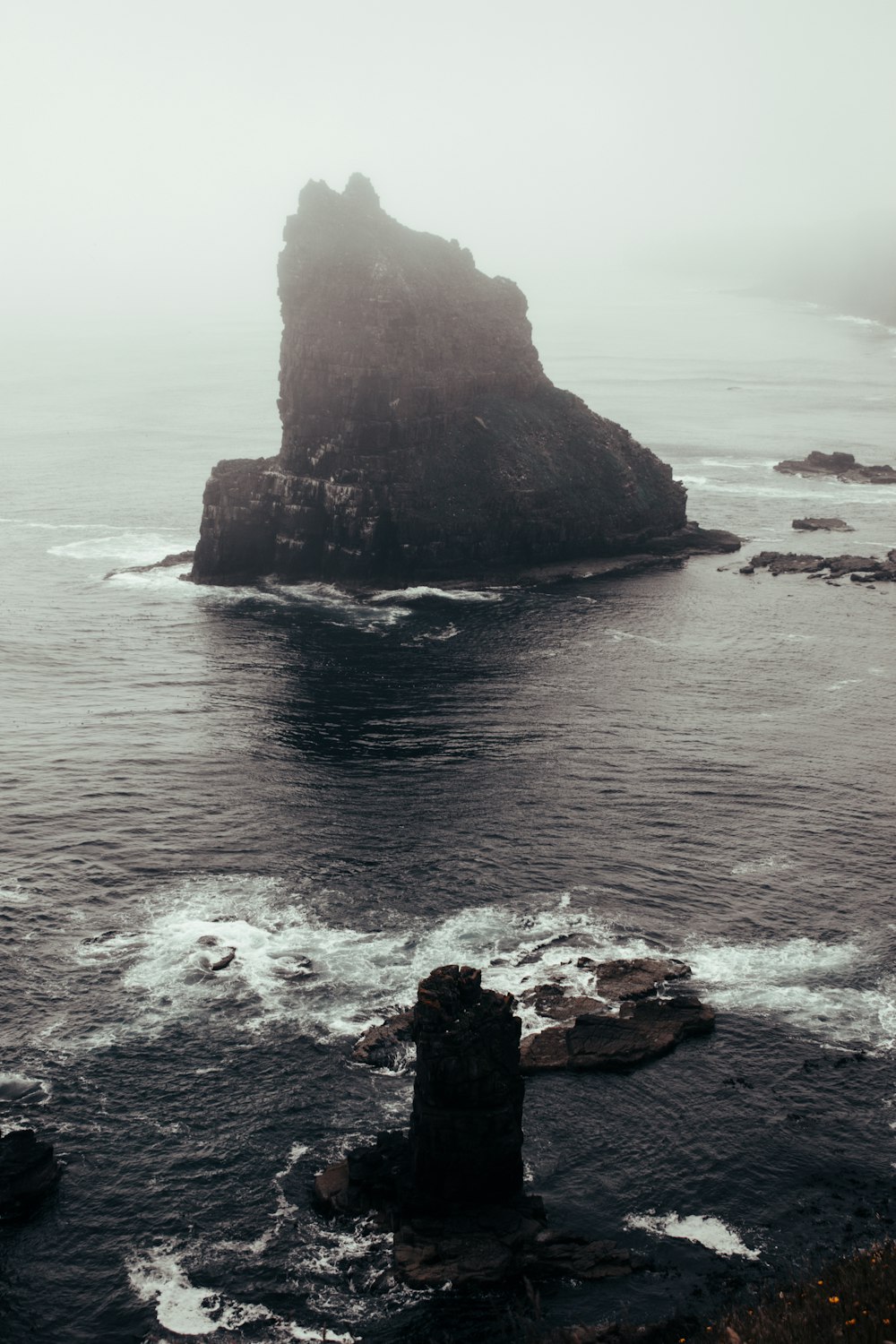 a rocky cliff next to the ocean