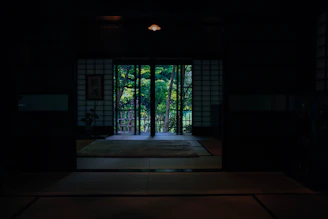 A peaceful dojo with wooden floors and traditional Japanese scrolls hanging on the walls.