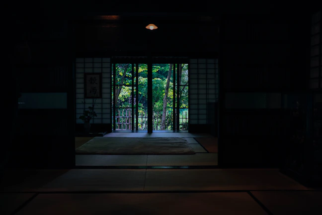 Warm spa room with soft lighting, candles, and wooden accents reflecting Japanese minimalism