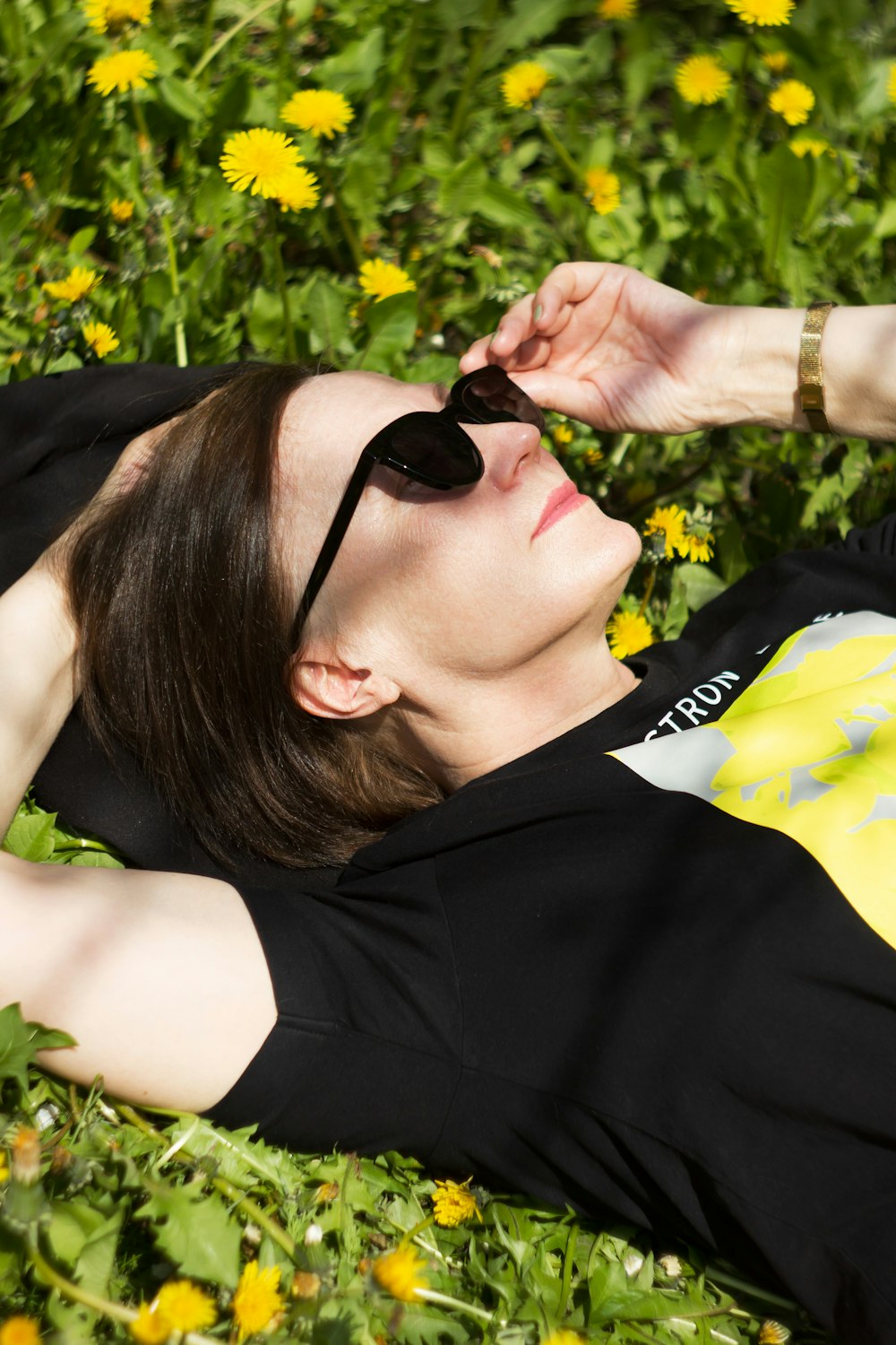 a person lying in a field of flowers