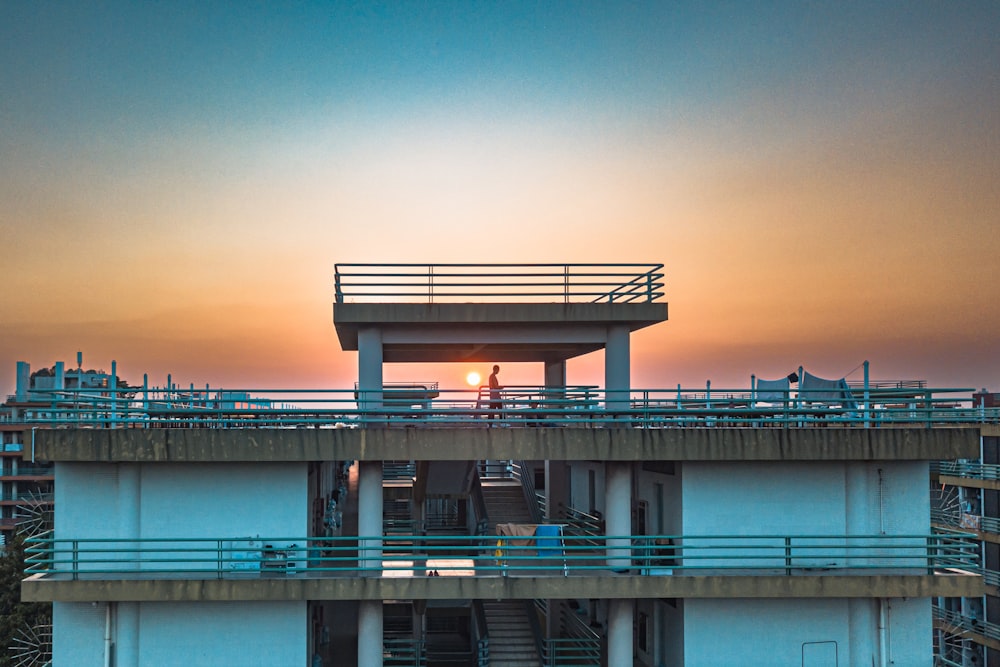 a building with a sunset in the background