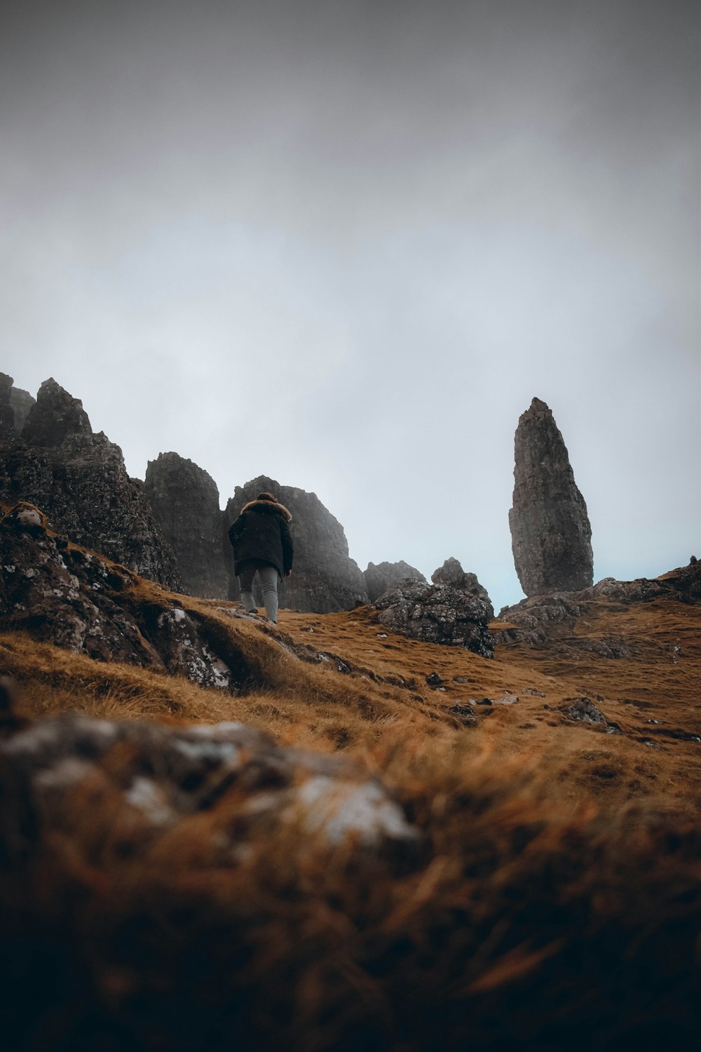 a person standing on a rocky hill