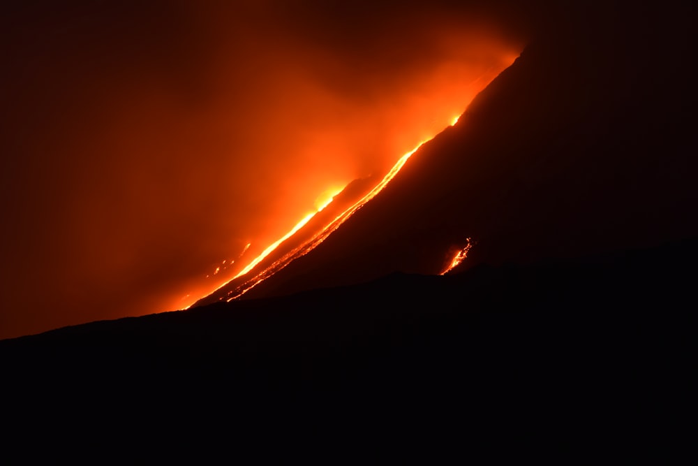 a volcano erupting at night