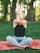 A serene yoga practitioner performing a sun salutation in a peaceful outdoor setting.