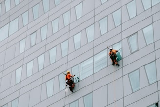 a few men climbing a building