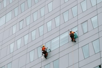 a few men climbing a building