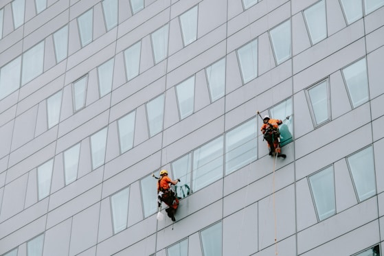 a few men climbing a building