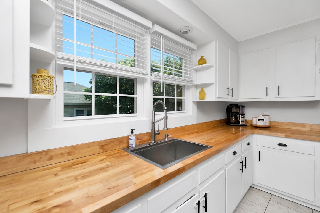 a kitchen with white cabinets,