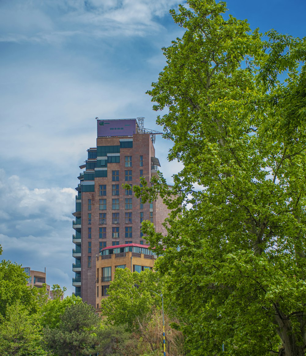 a tall building with trees in front of it