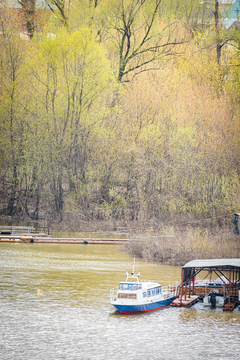 a boat is parked on the side of a river