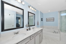 a double sink and large mirror