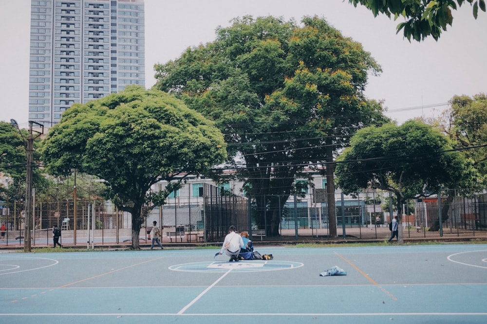 a couple of people sitting on a bench in a park