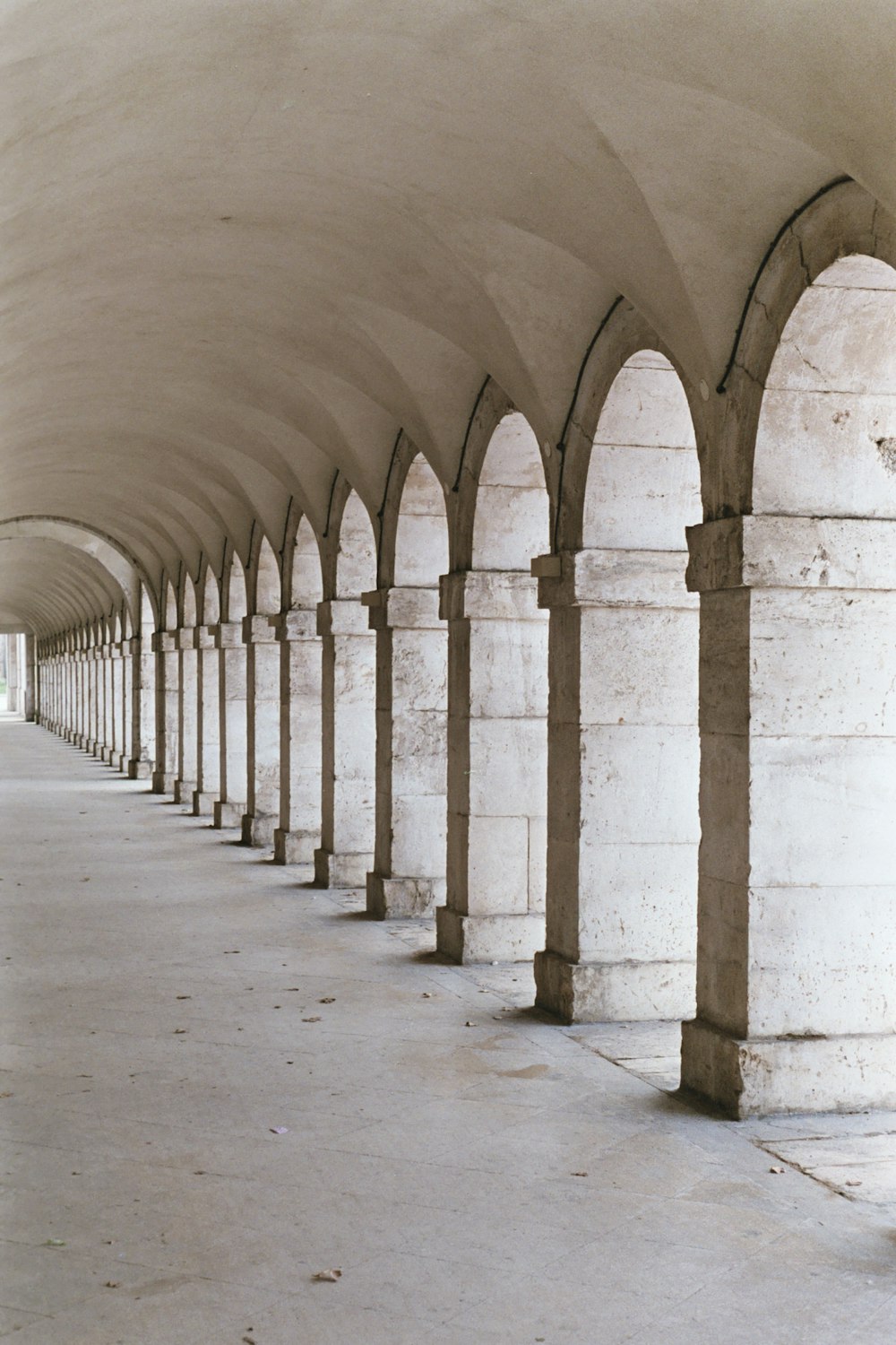 a concrete hallway with pillars