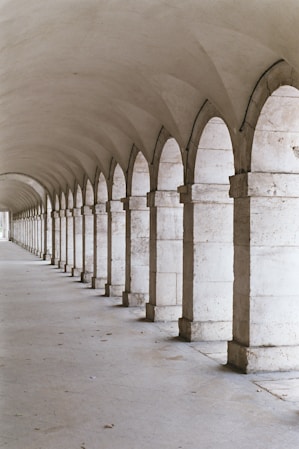 a concrete hallway with pillars