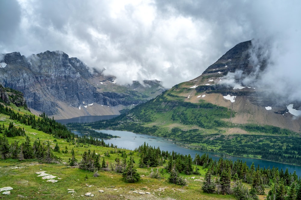 a river running through a valley between mountains