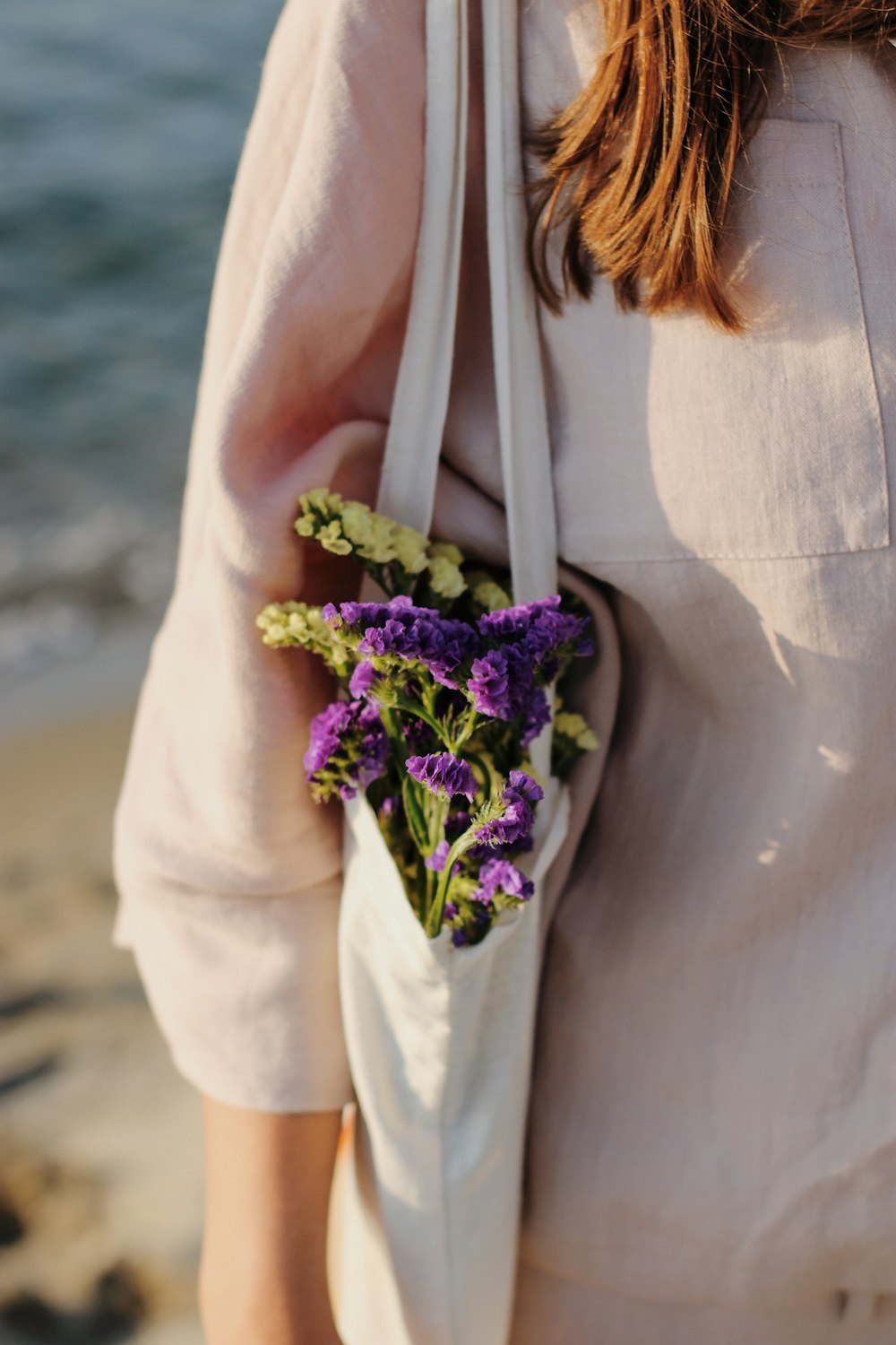 a woman wearing a white dress with flowers in her hair