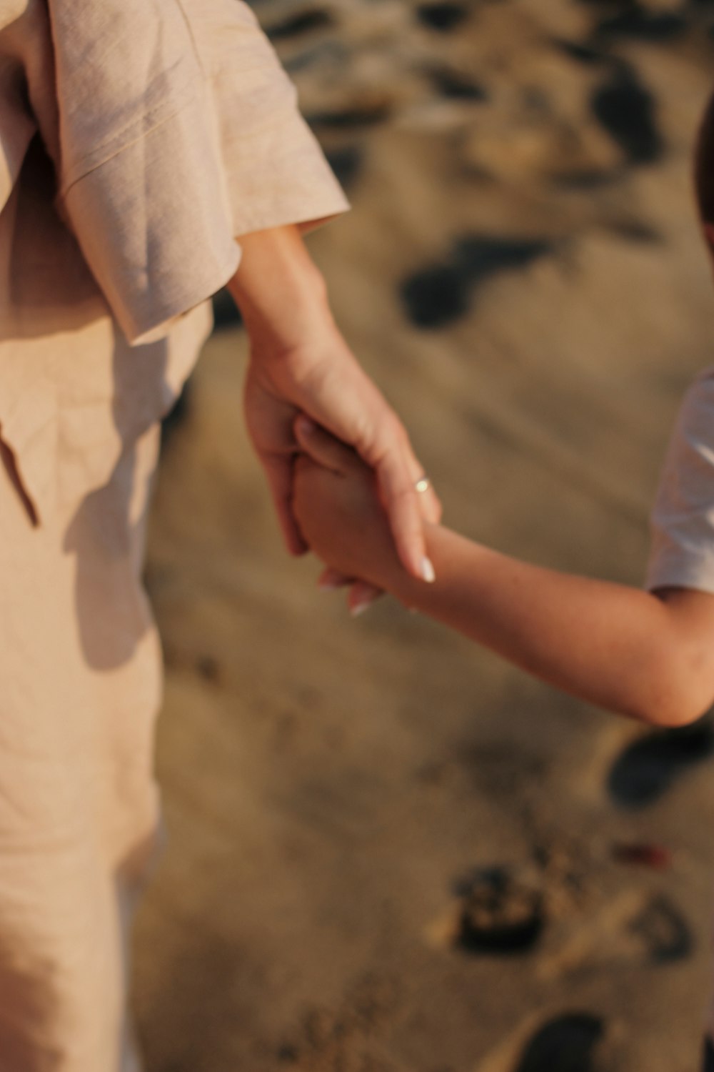 a person's hand touching a rock