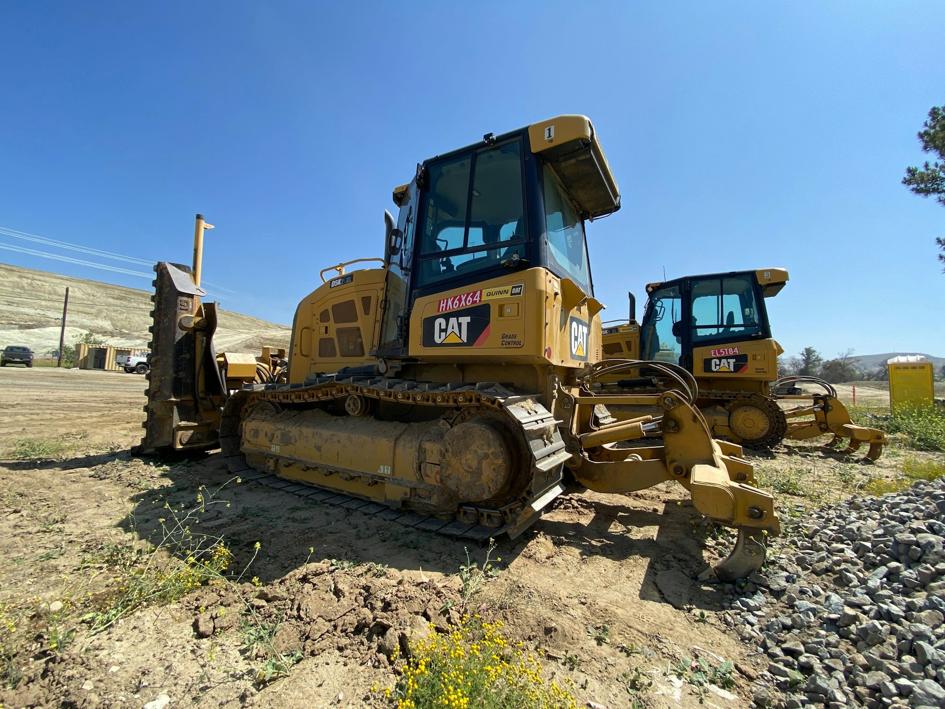 a yellow bulldozer in a field
