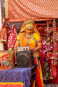 Friendly customer support agent assisting a traveler via headset with Indonesian cultural icons around