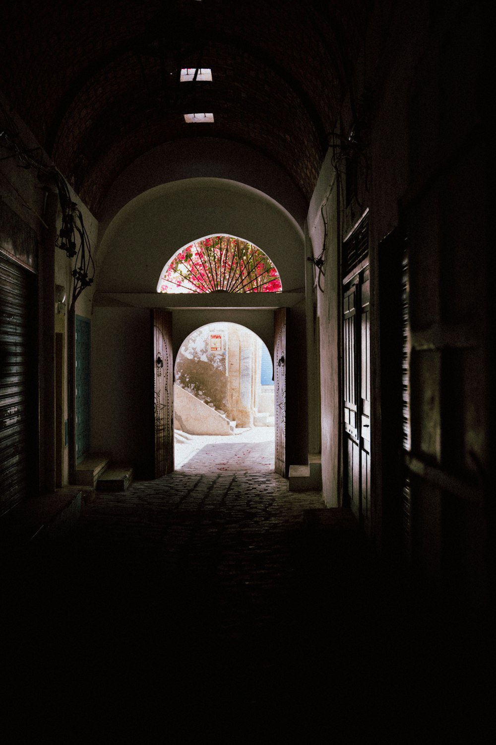 a dark hallway with a stained glass window