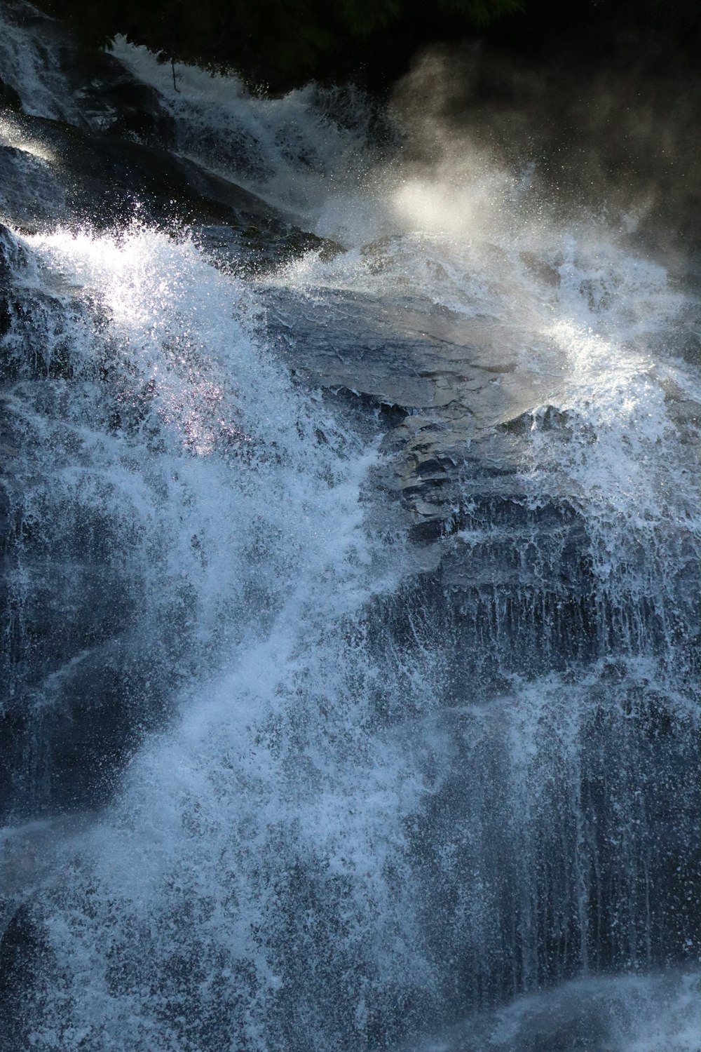 a waterfall with a rainbow