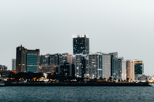 a city skyline with a body of water in the foreground
