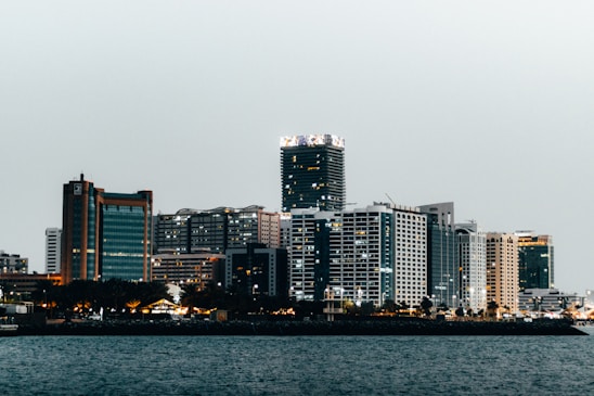 a city skyline with a body of water in the foreground