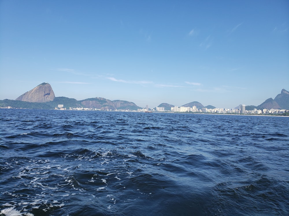 a body of water with a city in the distance