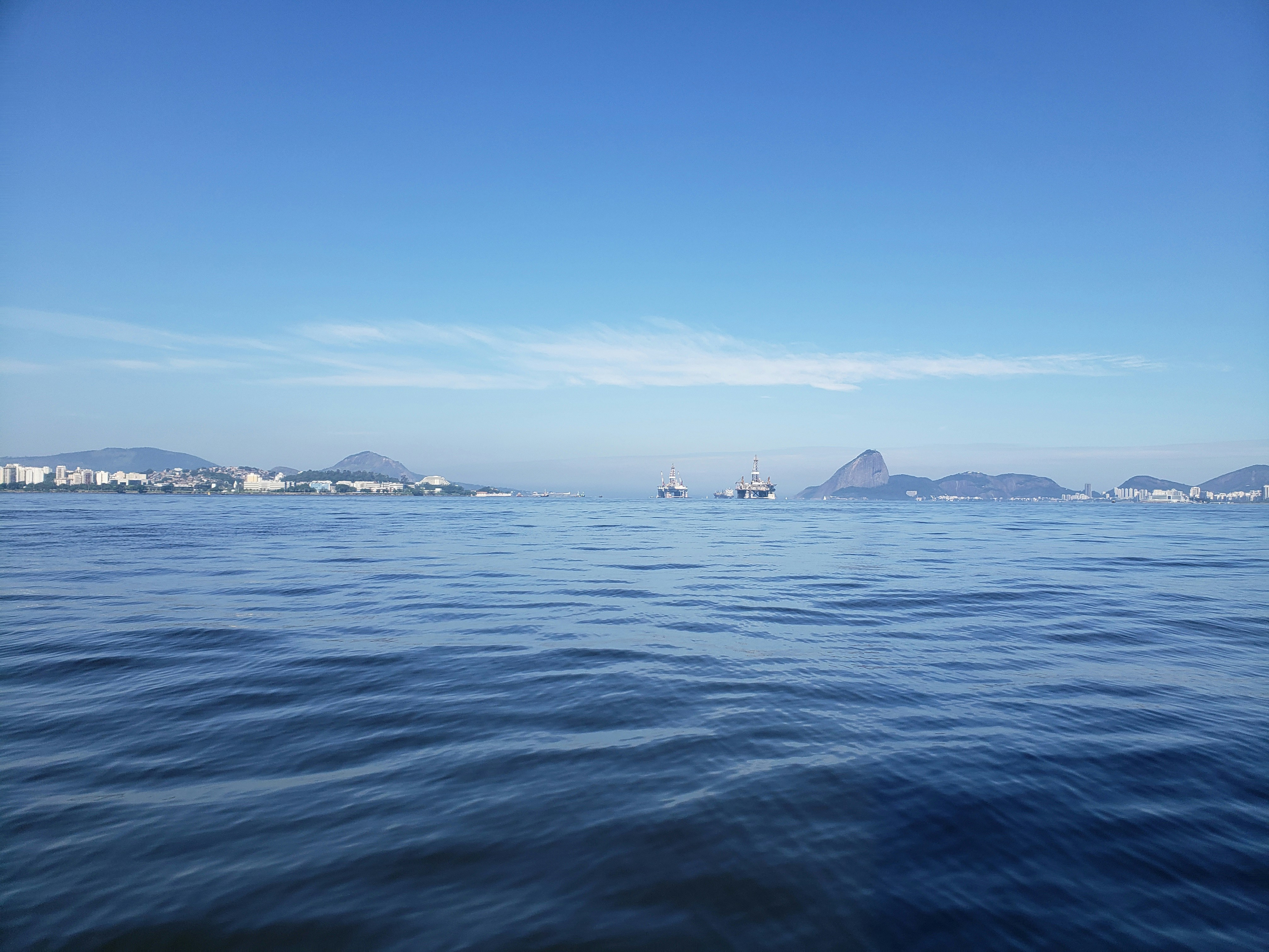 Two oil platforms in Rio de Janeiro with Sugarloaf mountain behind