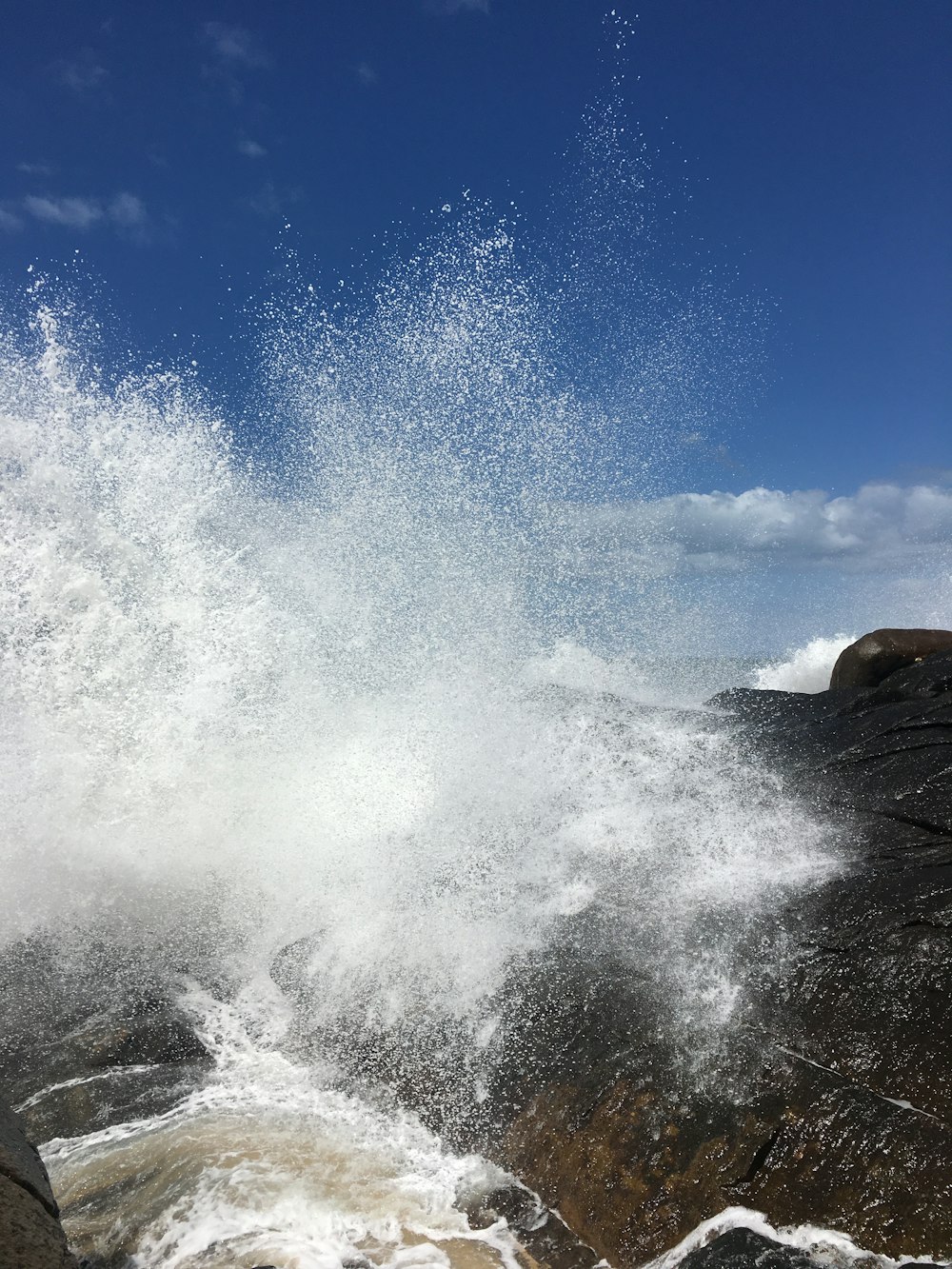 a large waterfall with clouds