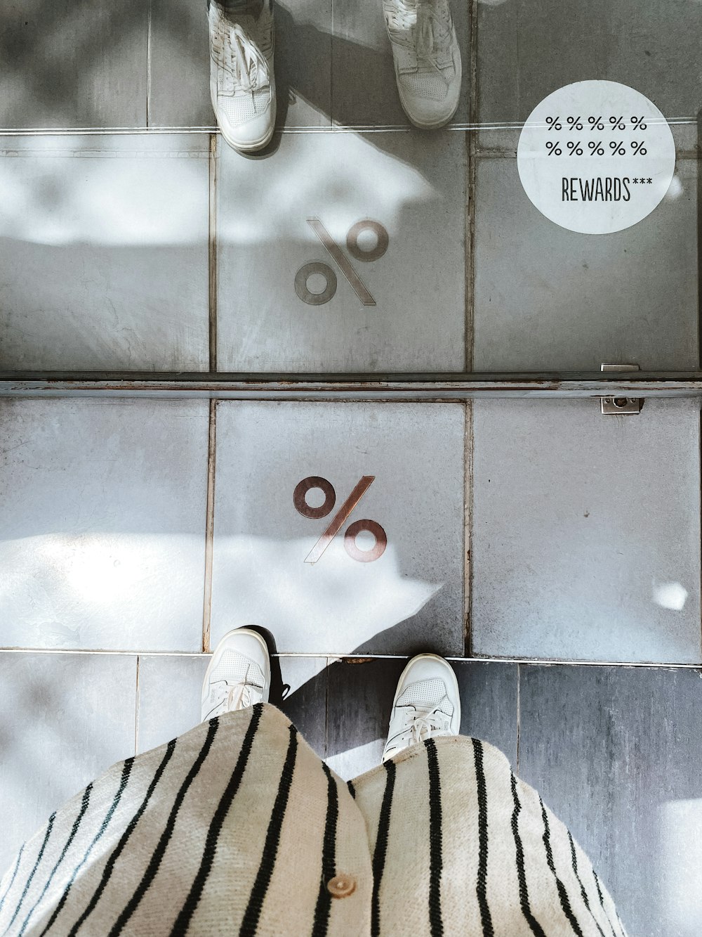 a person's feet in a shoe rack